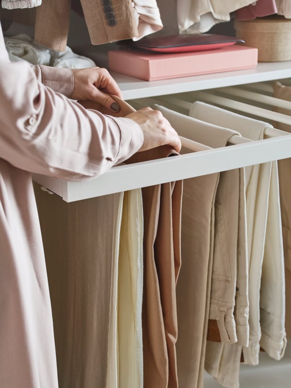A white KOMPLEMENT pull-out trouser hanger