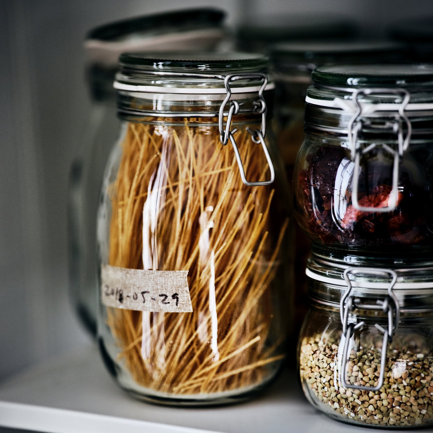 A clear glass KORKEN jar with lid