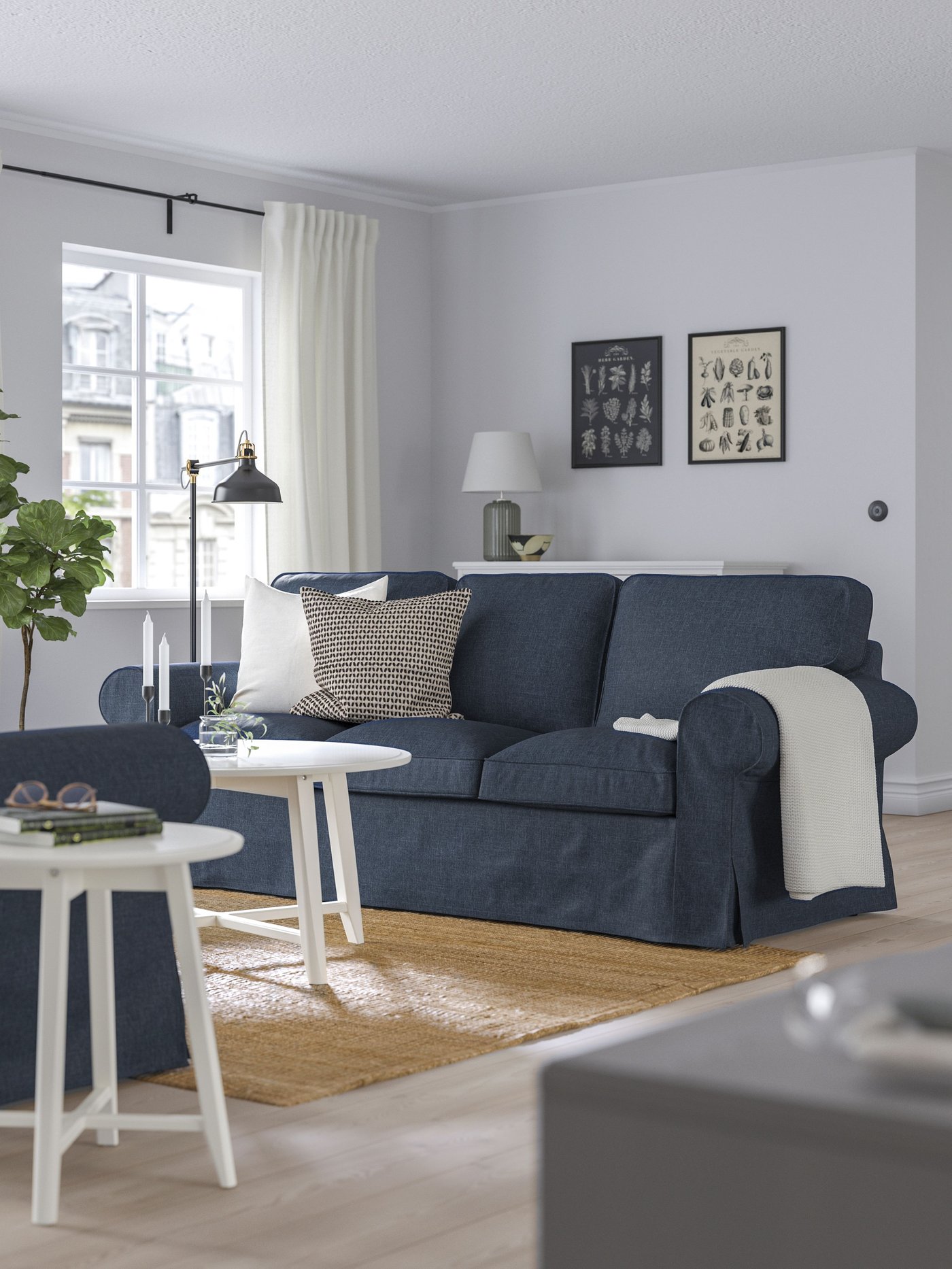 A Kilanda dark blue EKTORP 3-seat sofa in the living room