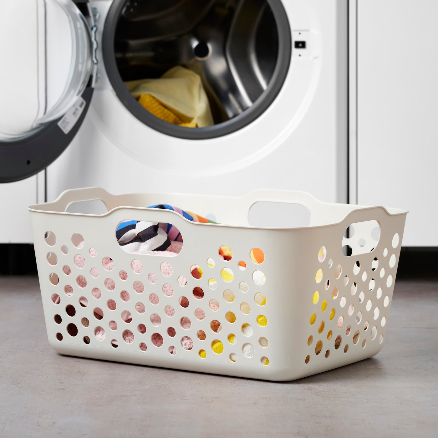 A white SLIBB laundry basket in the laundry room