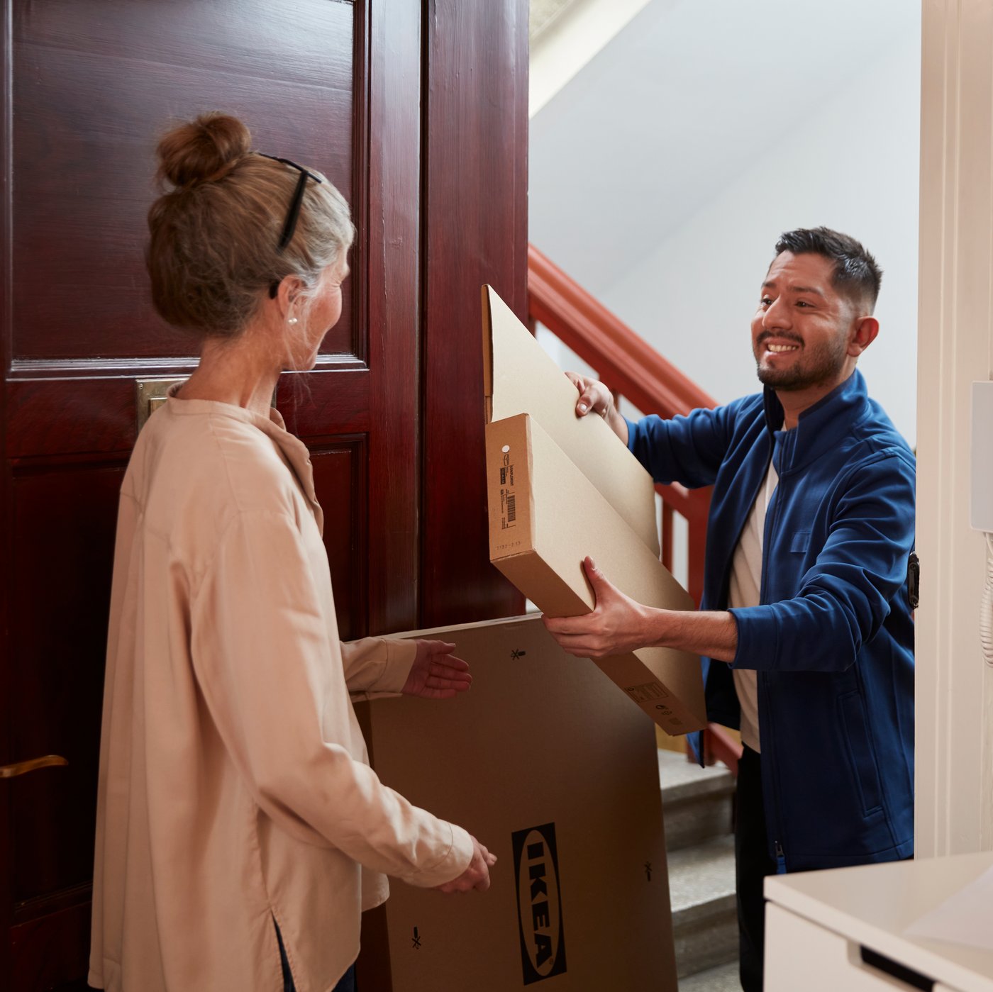 A customer receiving a package at the door.