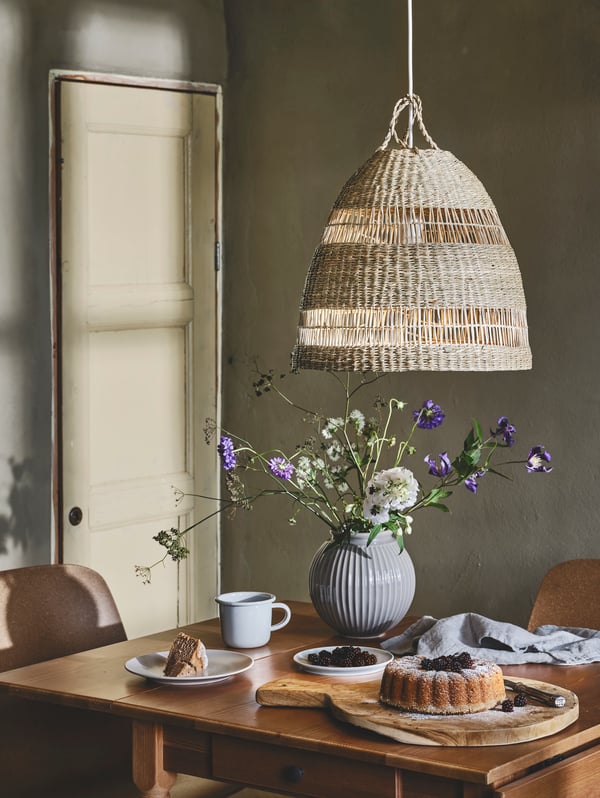 A country-style dining area with flowers on the table.