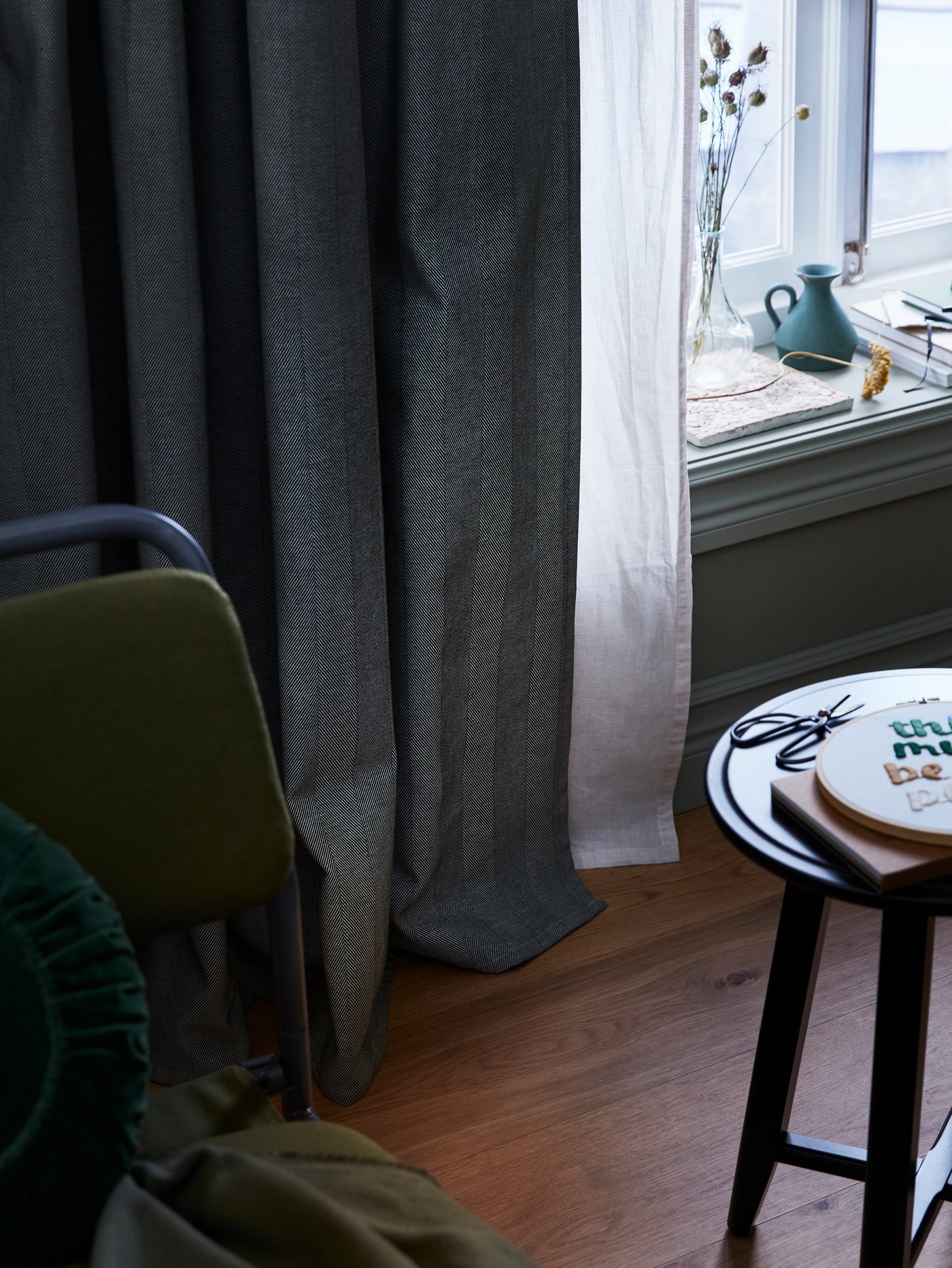 A black KRAGSTA nest of tables in the living room