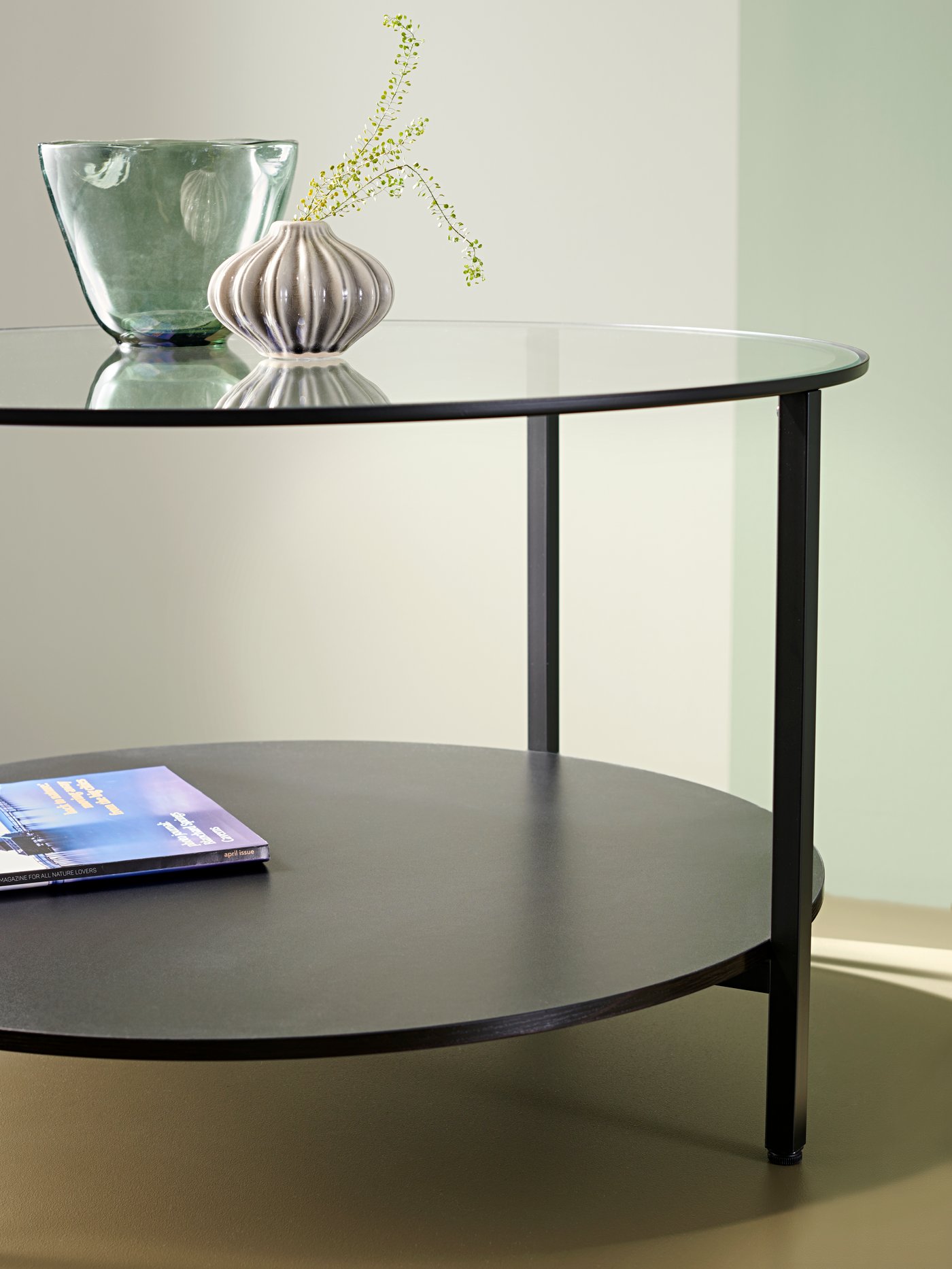A black coffee table in a small living room.