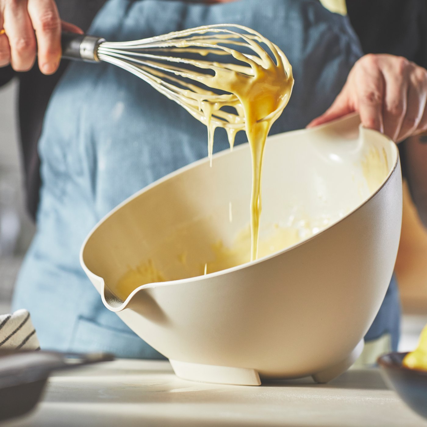 A beige VISPNING mixing bowl