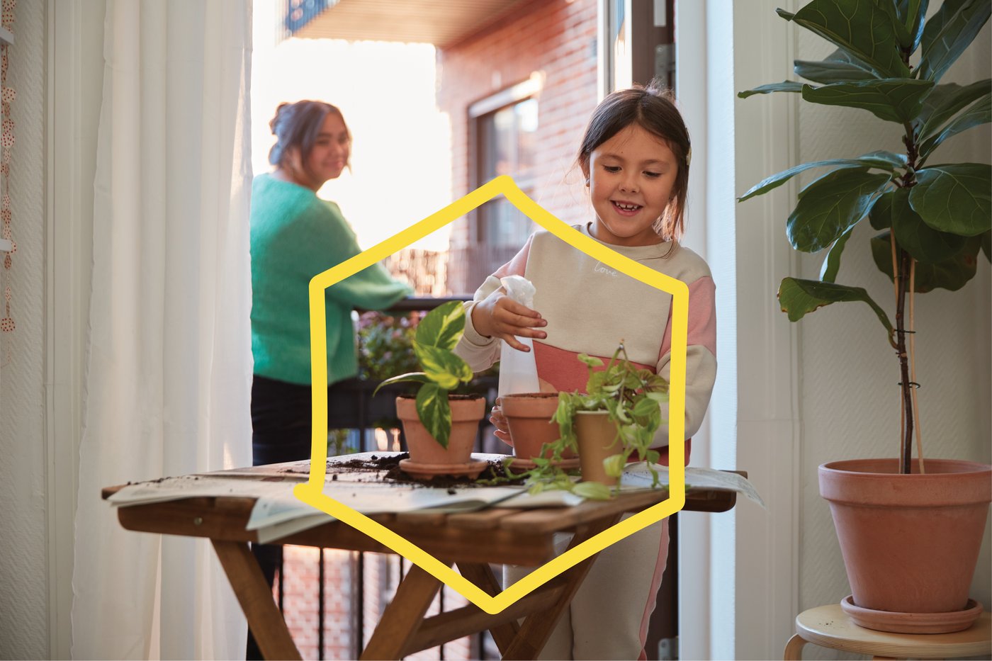 Girl watering in-house plants.