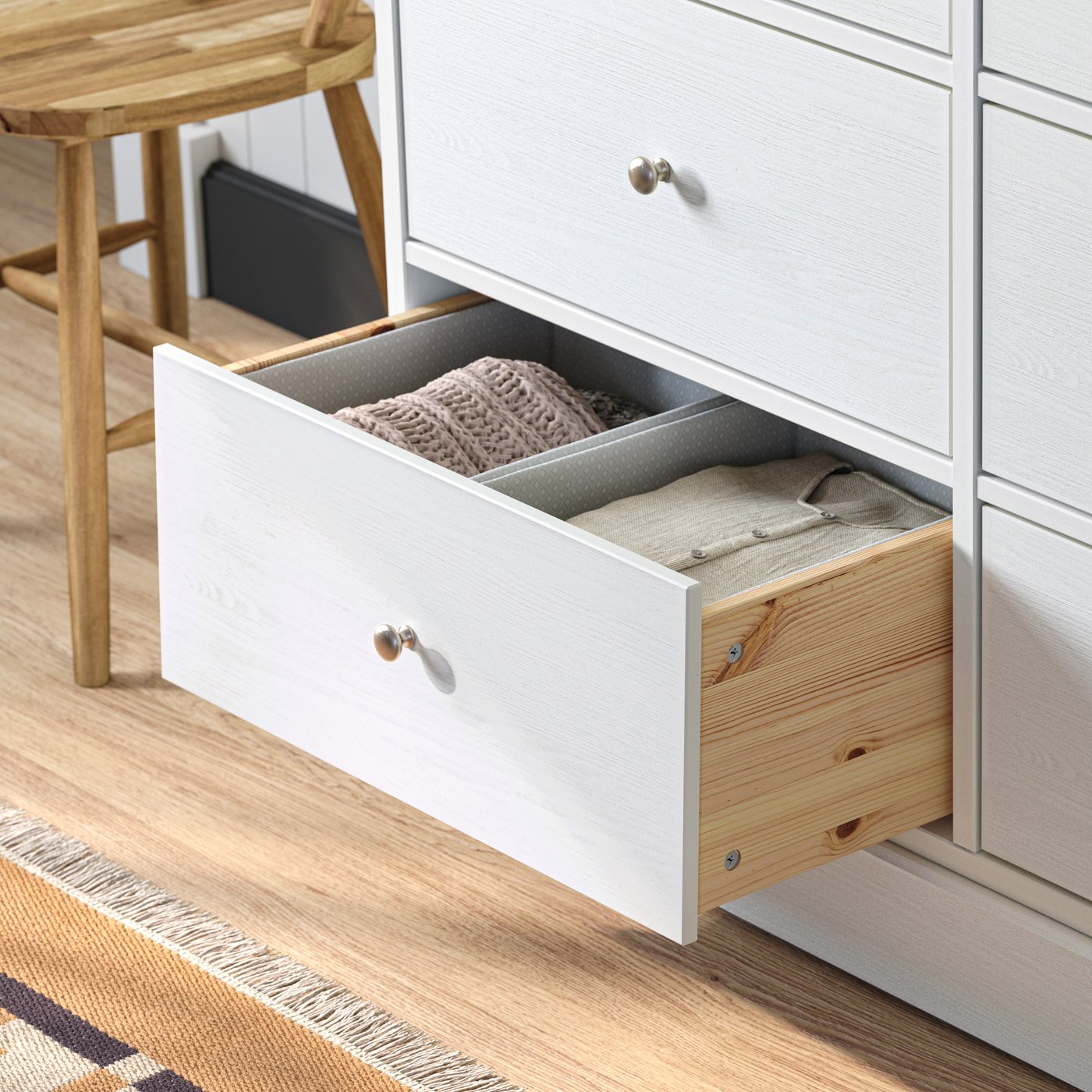 Close-up of HAVSTA chest of drawers with a drawer pulled out to show the neat order with organizing boxes inside.