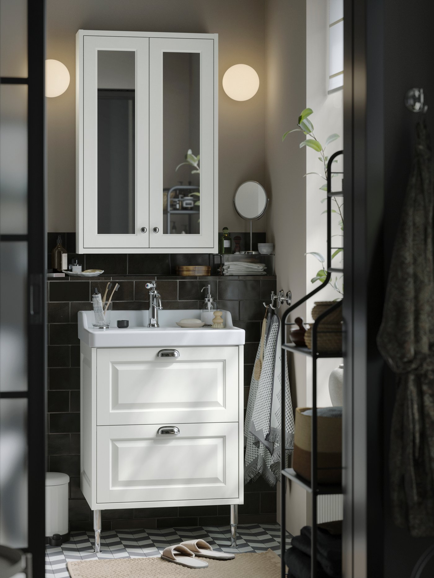 A bathroom with dark grey walls and a white TÄNNFORSEN cabinet
