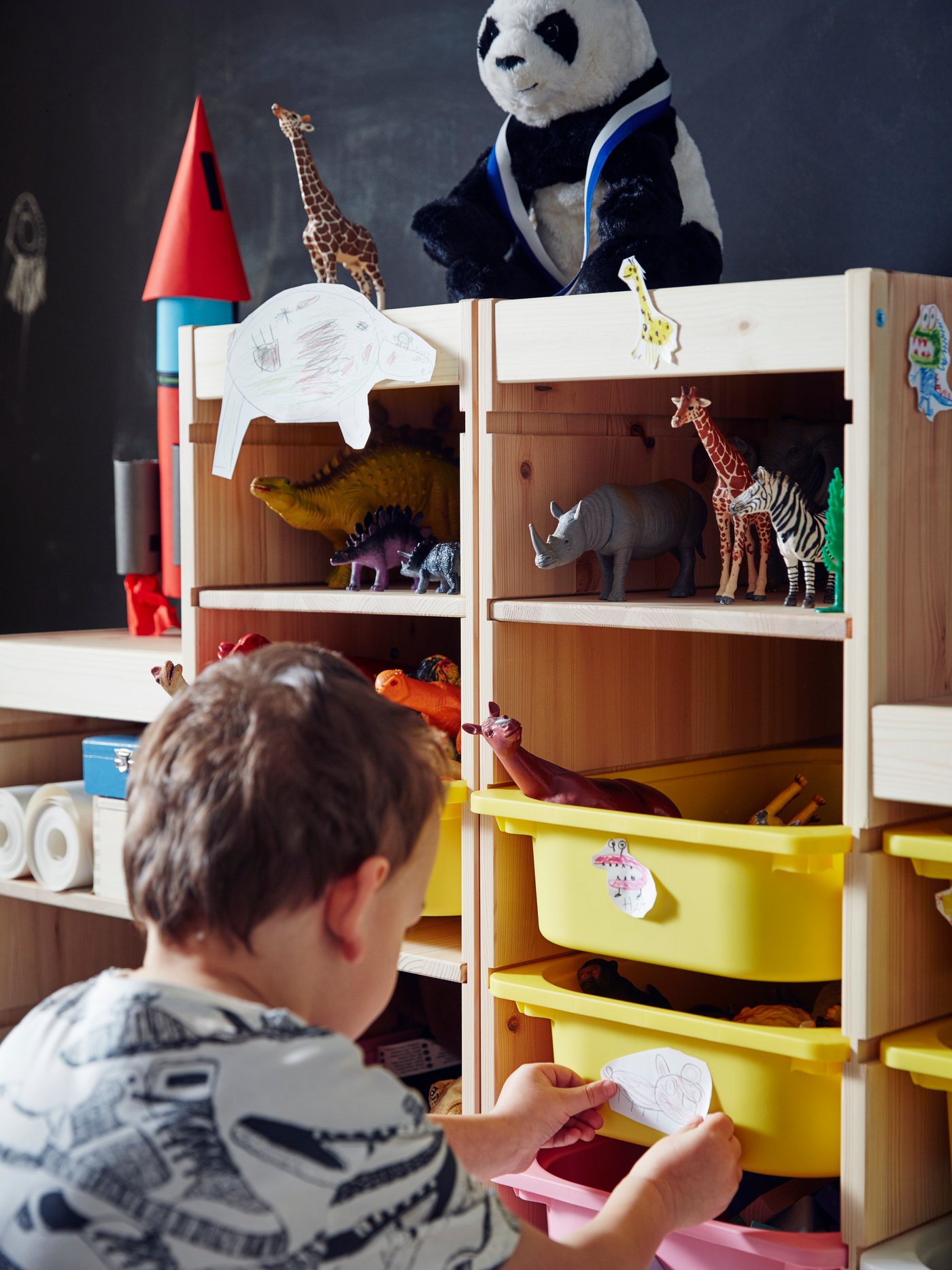 A white/black KRAMIG soft toy in the childrens room