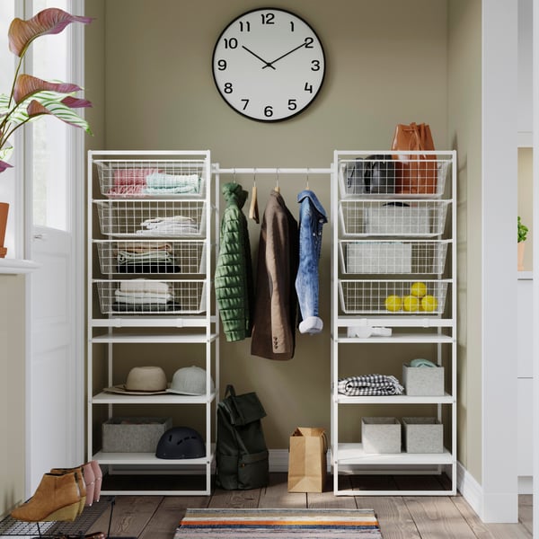 A neatly organised JONAXEL system with jackets hanging from a rail and shelves and drawers organised to perfection.
