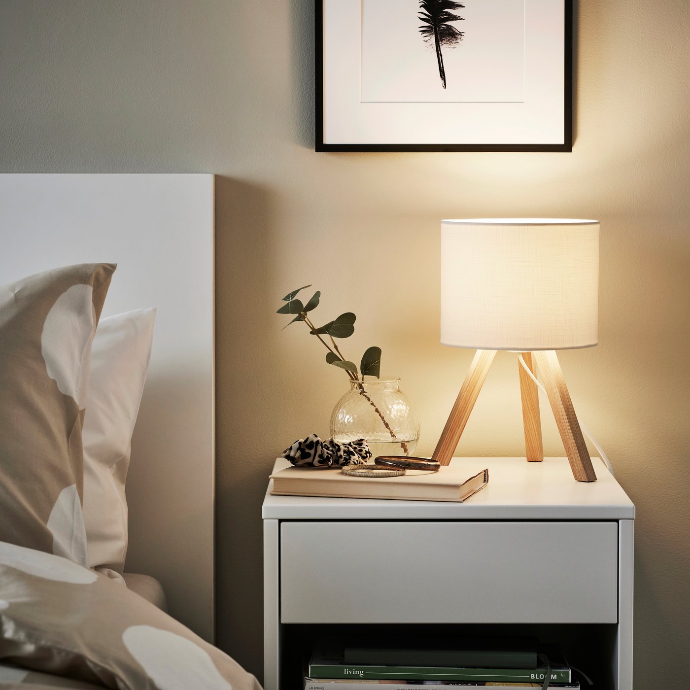 An ash/white STORSEGEL table lamp in the bedroom