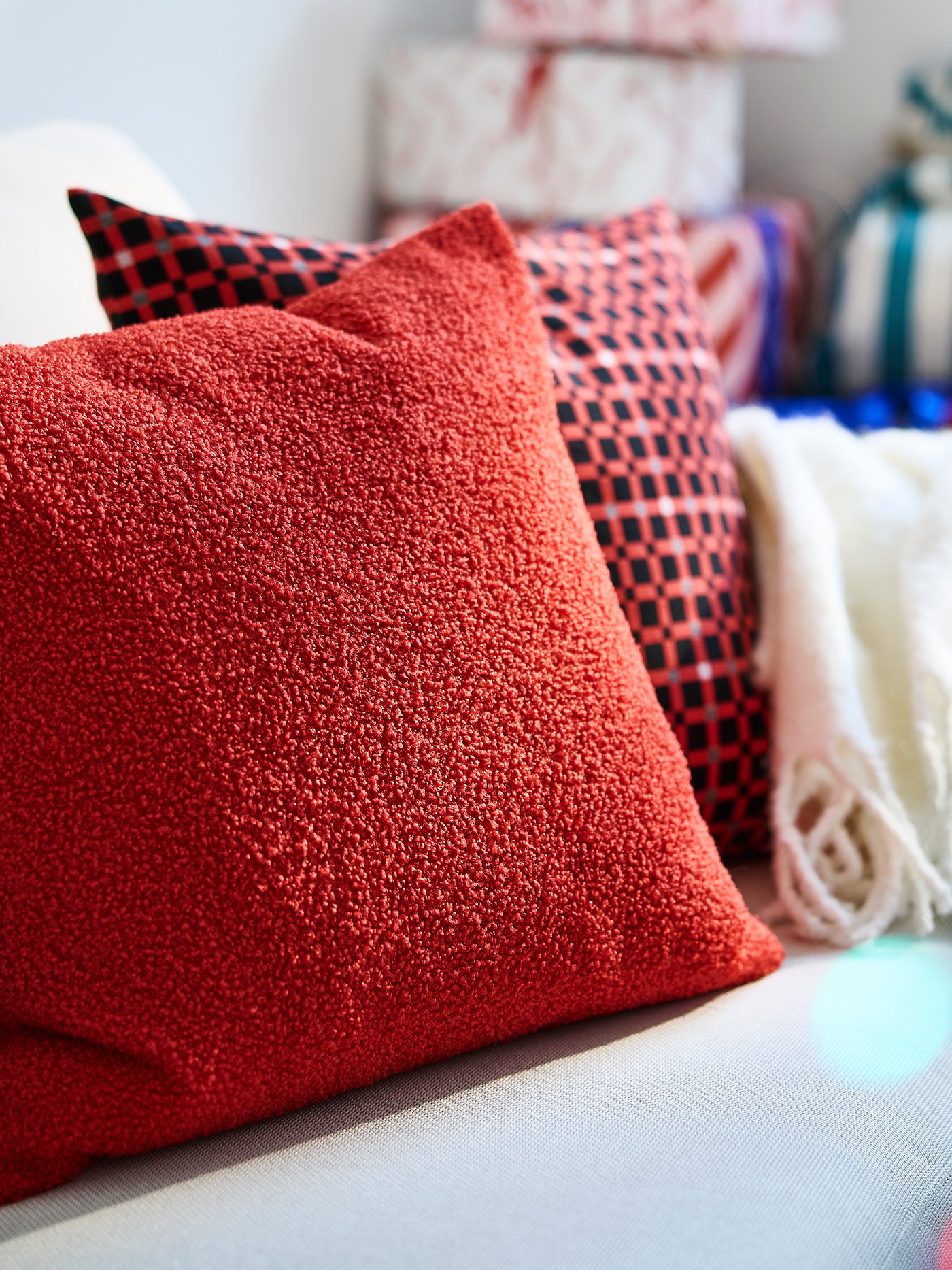 A check pattern red VINTERFINT cushion cover in the living room