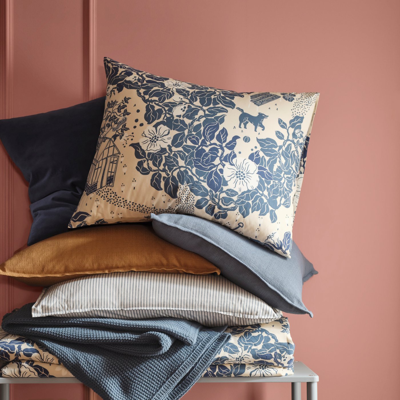 Pillows stacked with a floral pattern at the top