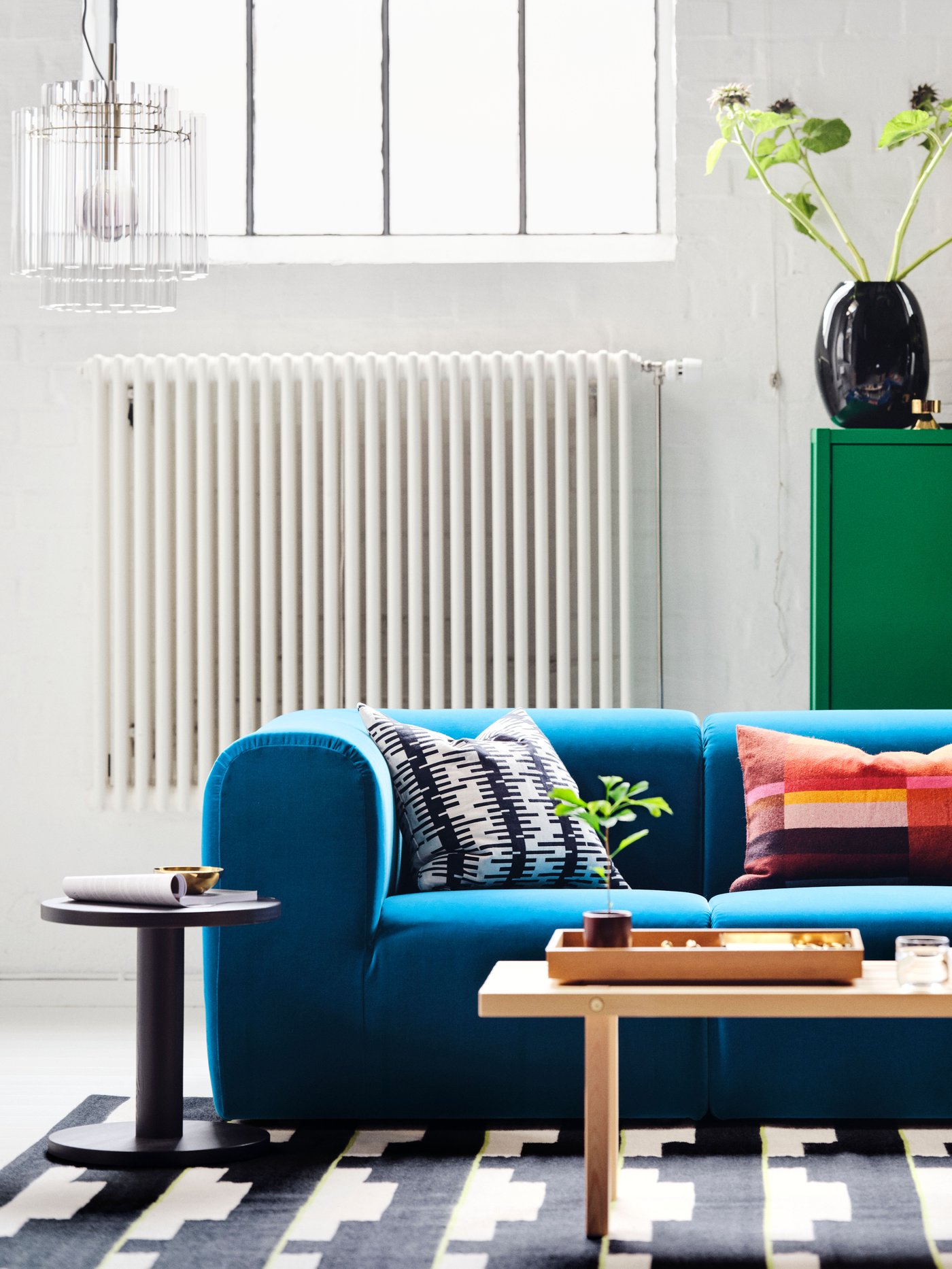 A green STOCKHOLM 2025 cabinet with 2 doors in the living room