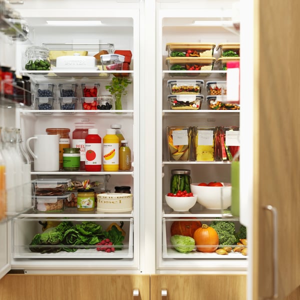 Food items are organised and stored inside two spacious SUPERKALL built-in refrigerators with SINARP fronts in oak veneer.