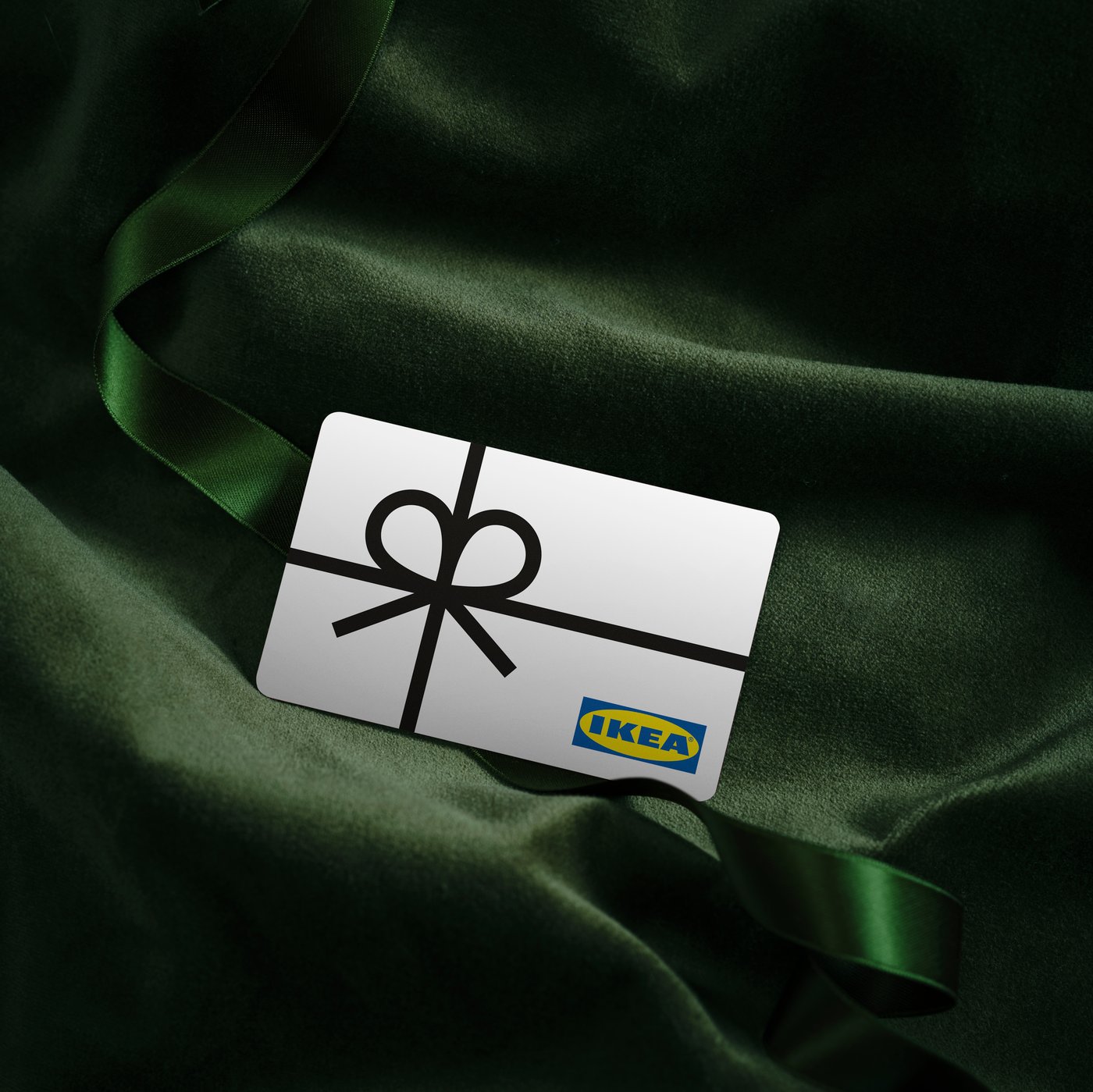 A IKEA Gift card on a dark green background.