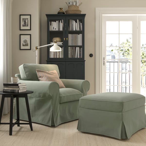 A Hakebo grey-green EKTORP armchair