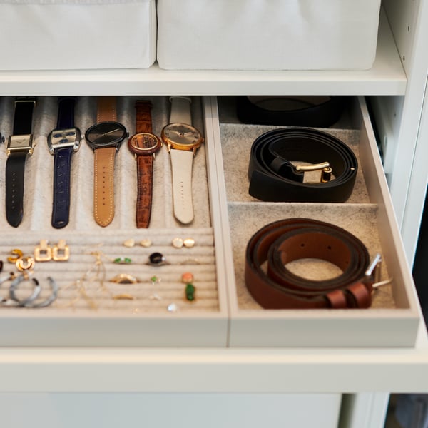 A light grey KOMPLEMENT insert for pull-out tray in the bedroom