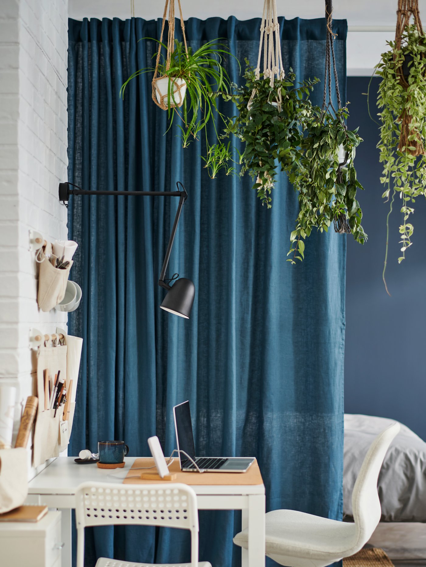 A small bedroom and a work space part with curtains