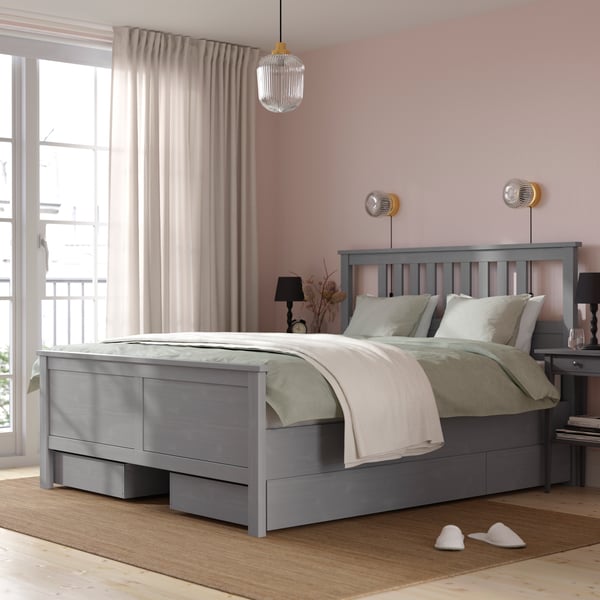 A grey stained HEMNES bed frame with 4 storage boxes