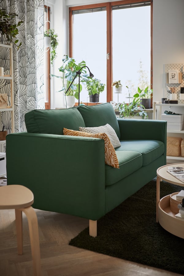 A grey-turquoise PÄRUP sofa in a living room setting