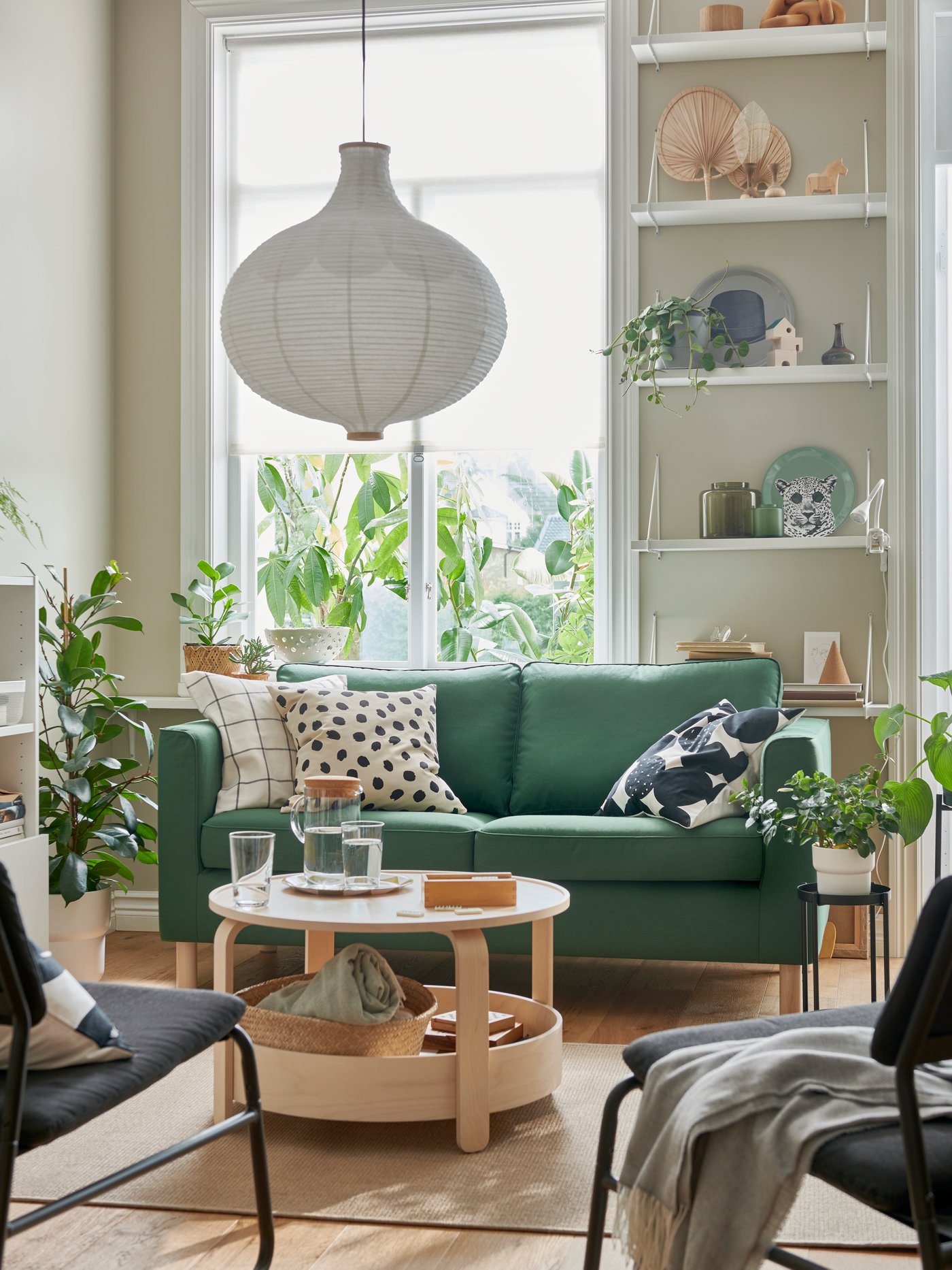 A green sofa in a bright living room.