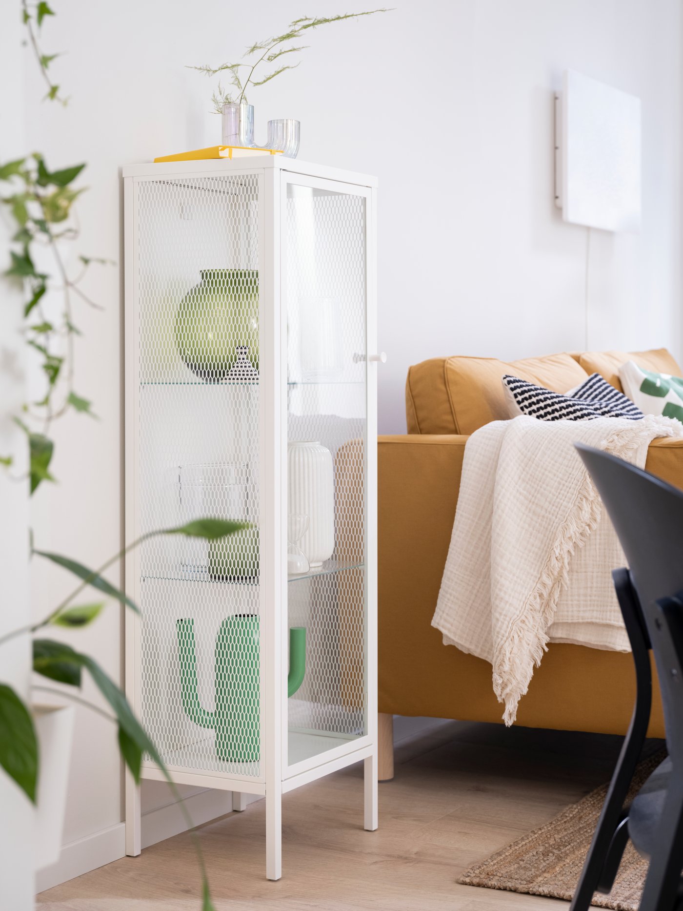 A green KONSTFULL vase in the living room