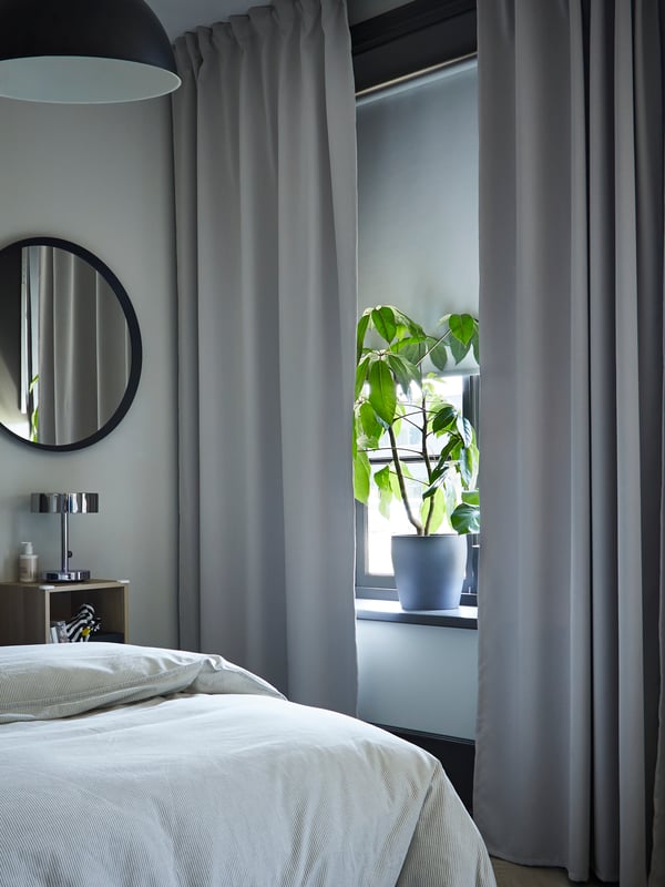 A dark grey LANGESUND mirror in the bedroom