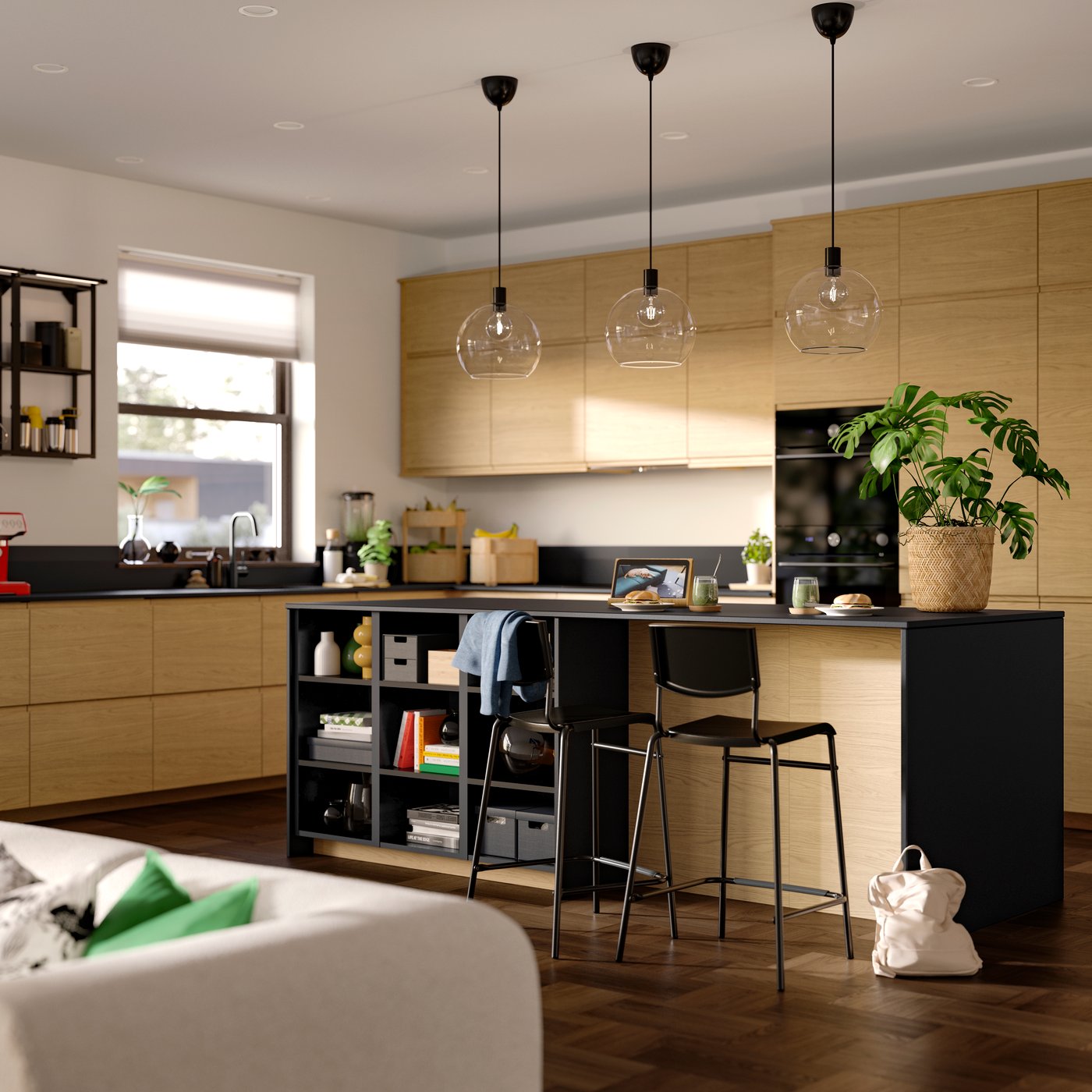 A dining room with VOXTORP oak effect drawer fronts and doors, three ceiling lamps hanging, wall frame shelves and chairs.