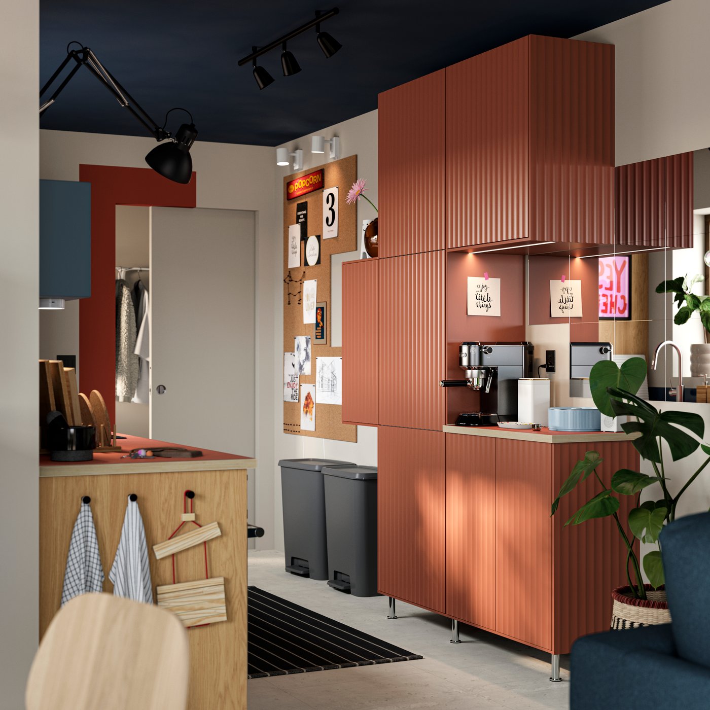 Several SEKTION kitchen cabinets with TERRSJÖ doors with a red-brown wave pattern are mounted on a wall in a small kitchen.