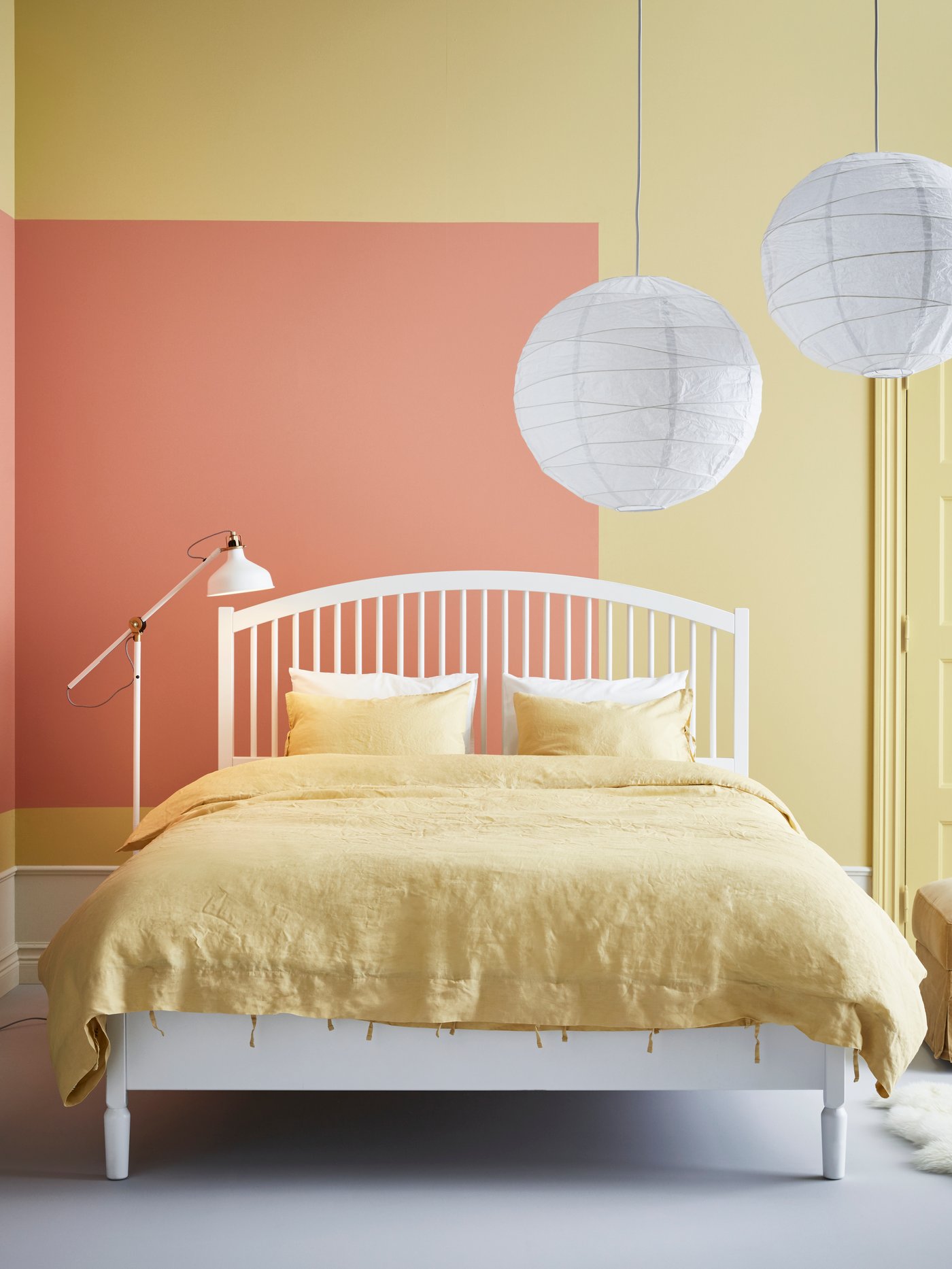 An off-white RANARP floor/reading lamp in the bedroom