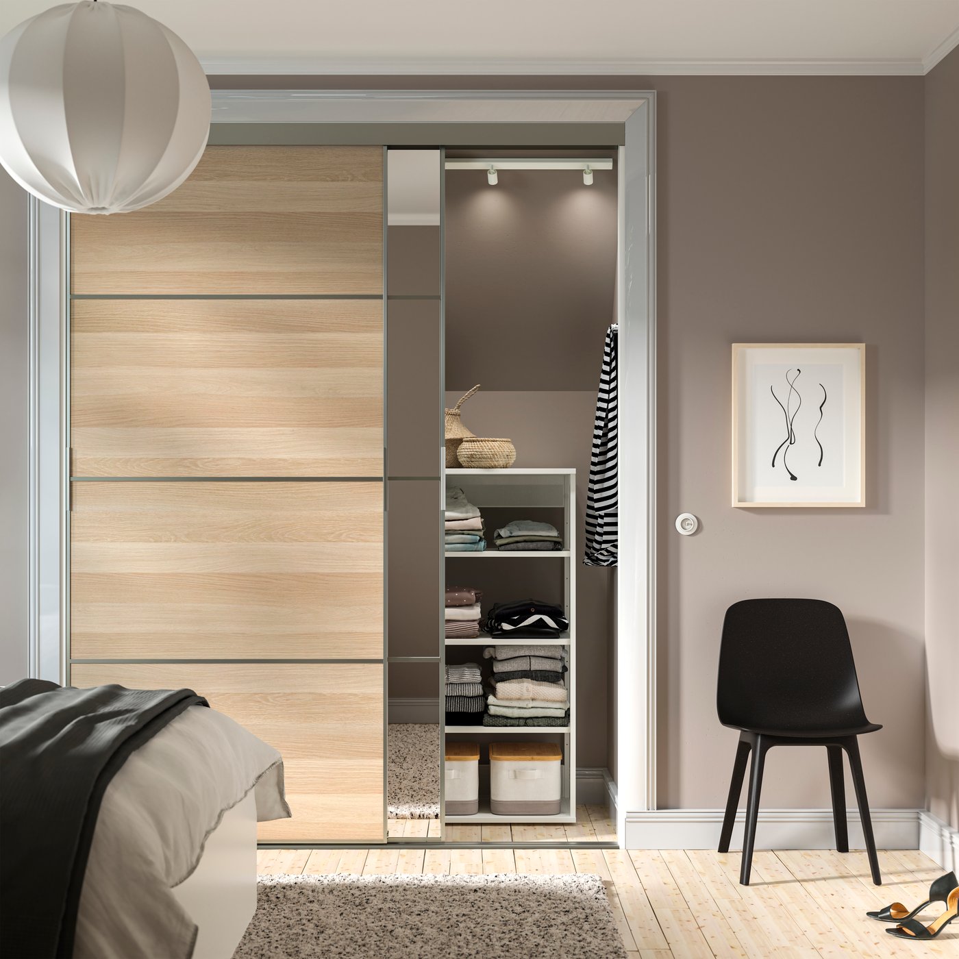 A round white REGNSKUR pendant lampshade in the bedroom