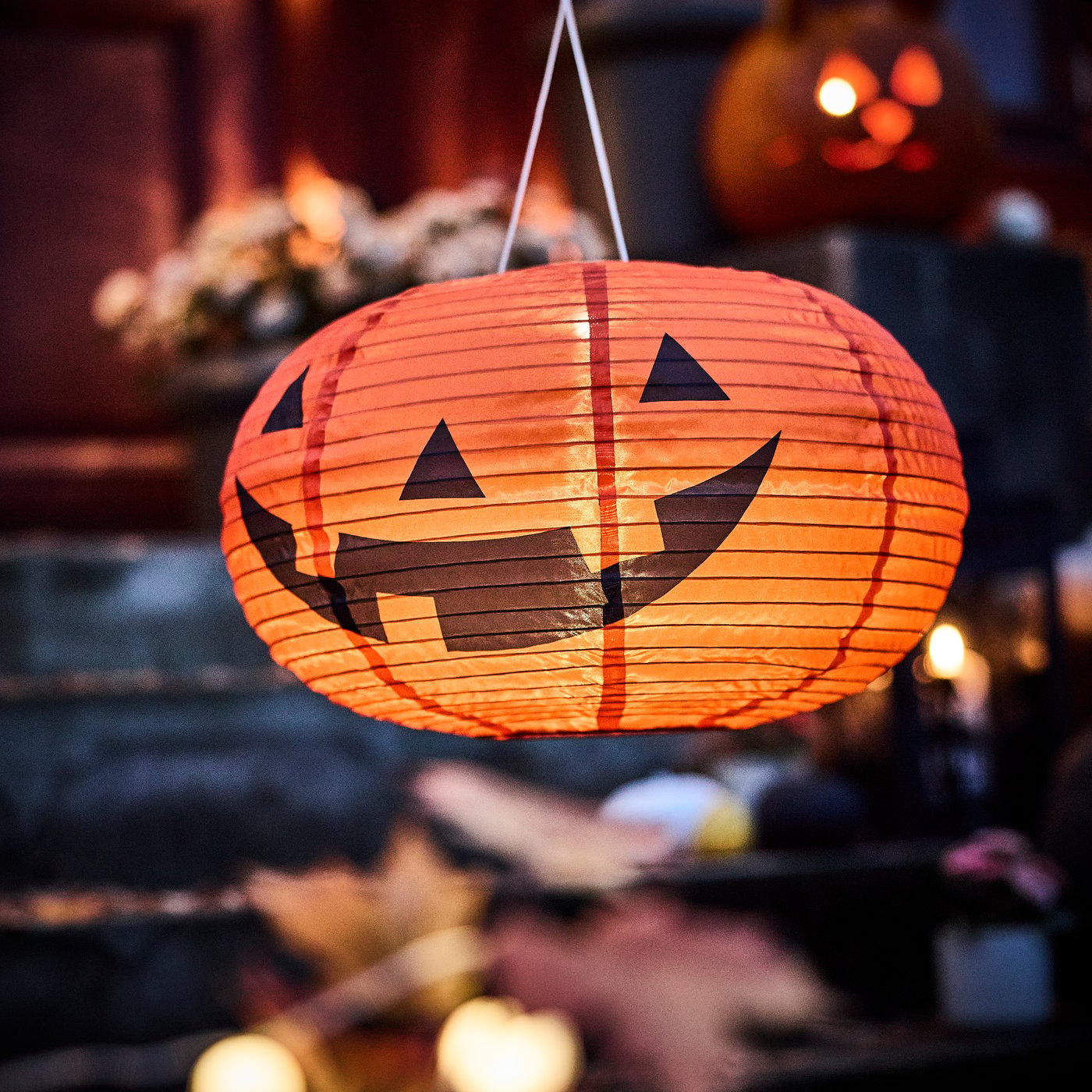 A pumpkin battery-operated/outdoor orange KUSTFYR LED pendant lamp outside