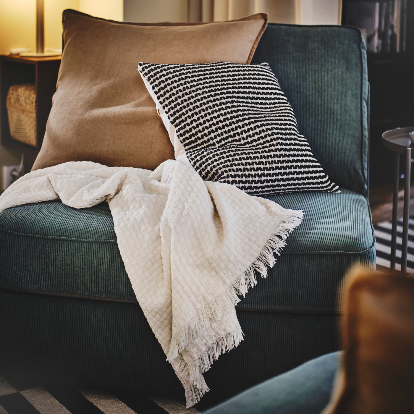 A dark beige DYTÅG cushion cover in the living room