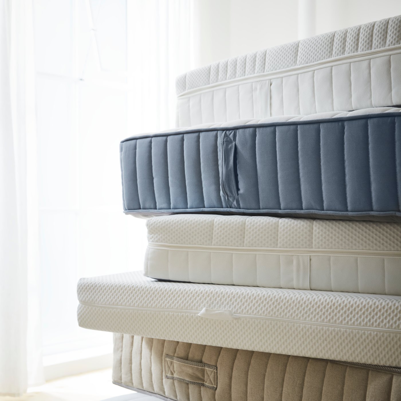 A firm/white ÅNNELAND hybrid mattress