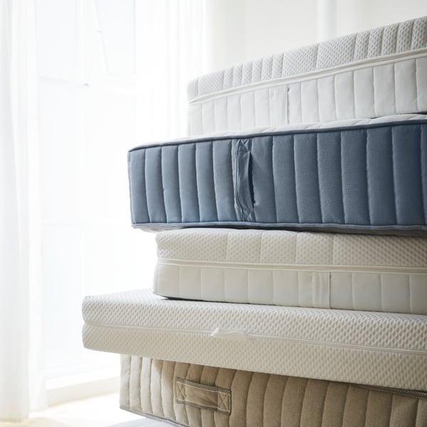 A firm/white ÅNNELAND hybrid mattress
