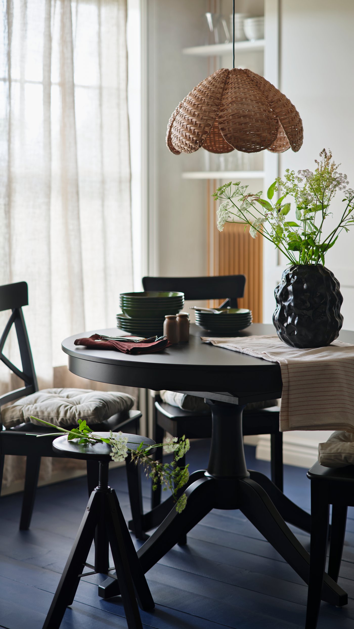 A handmade/rattan SANDKORN pendant lampshade in the dining room