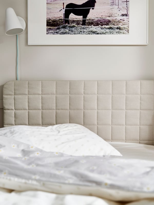 A Vissle beige SLÄKT headboard with cover