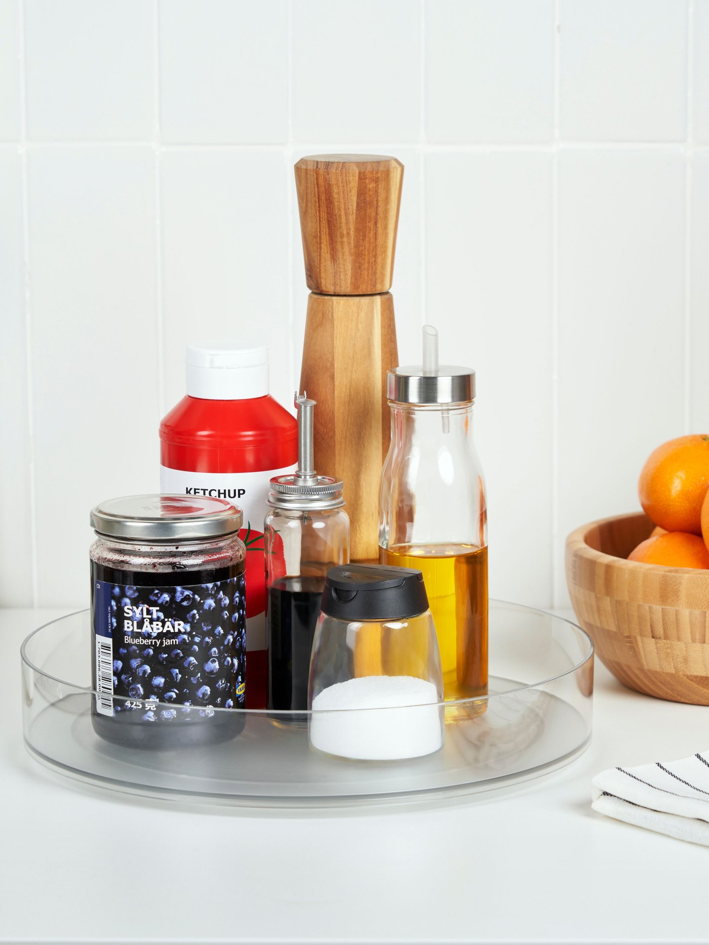 KLIPPKAKTUS drejebakke til opbevaring på et køkkenbord med tilbehør som olivenolie, salt og ketchup.
