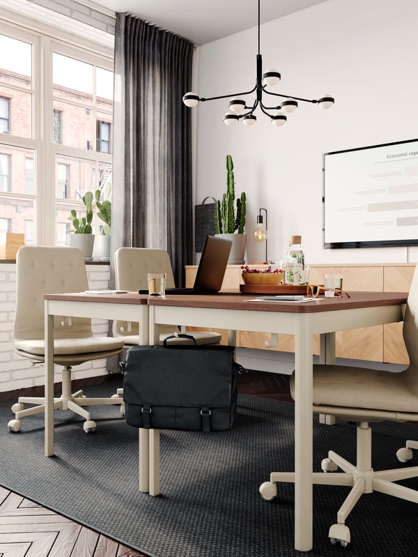 Two beige IDÅSEN tables are placed together in a conference room to create a big meeting table.