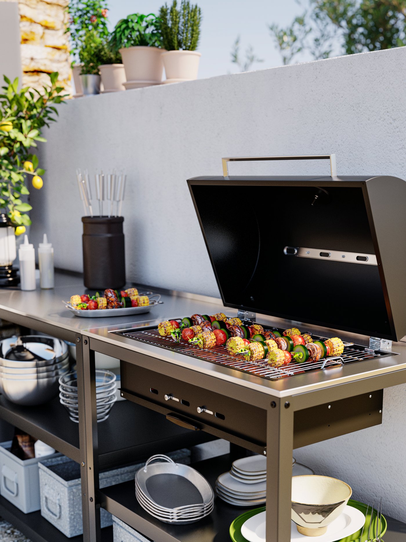 A charcoal barbecue with the hood open and vegetable skewers on the grill. Trays and plates are on the shelves below.