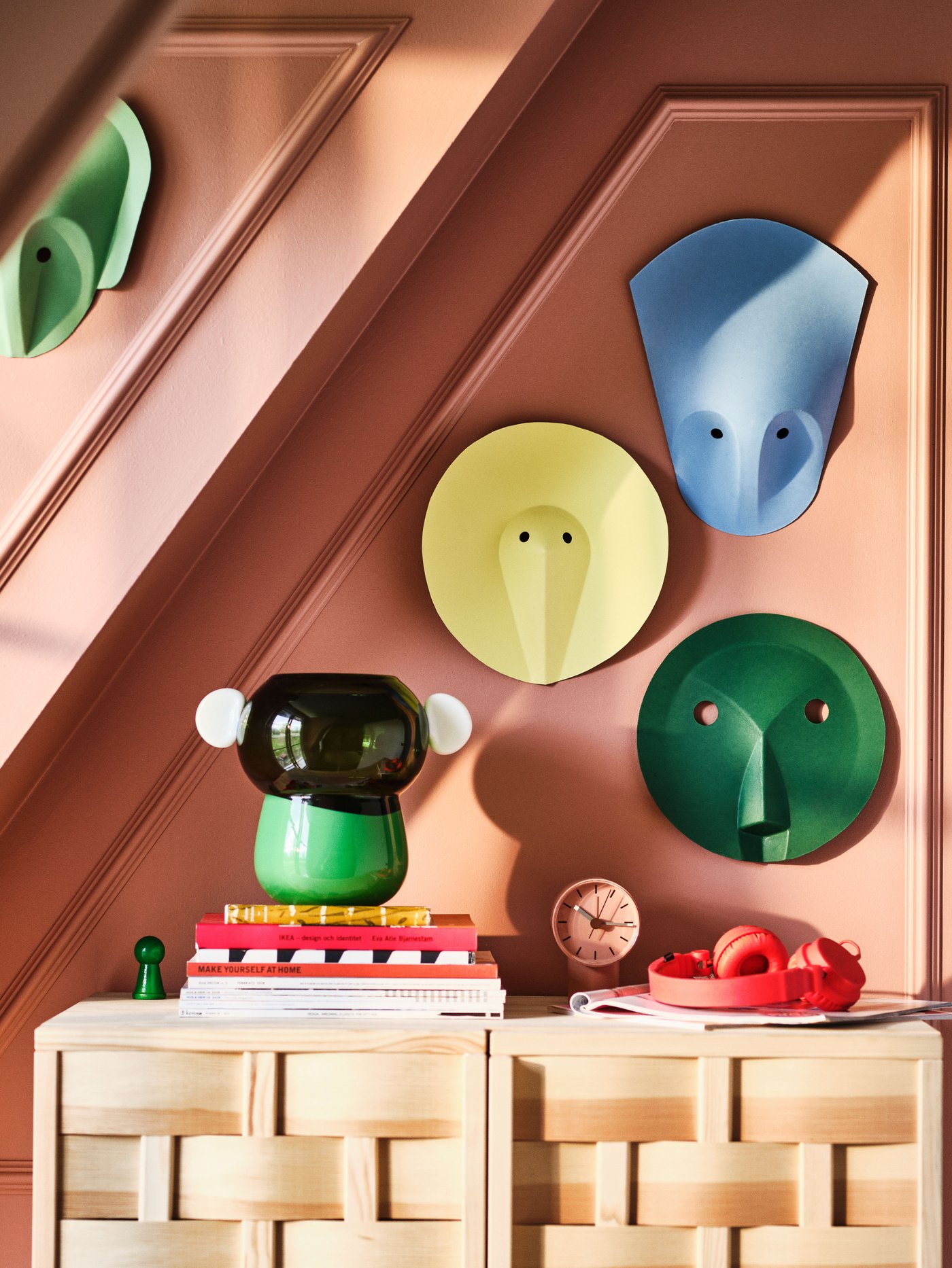 A pink red/blue IKEA PS 2026 wall decoration in the hallway