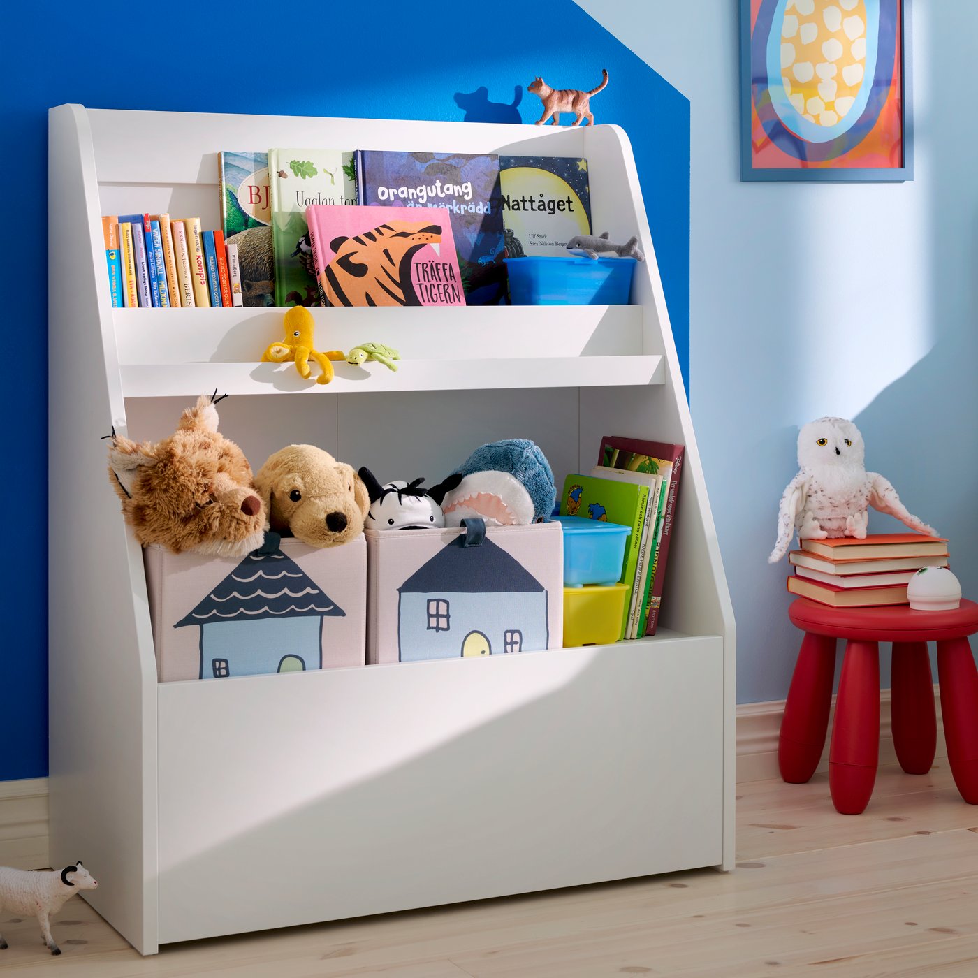 A white BERGIG book display with storage in the childrens room