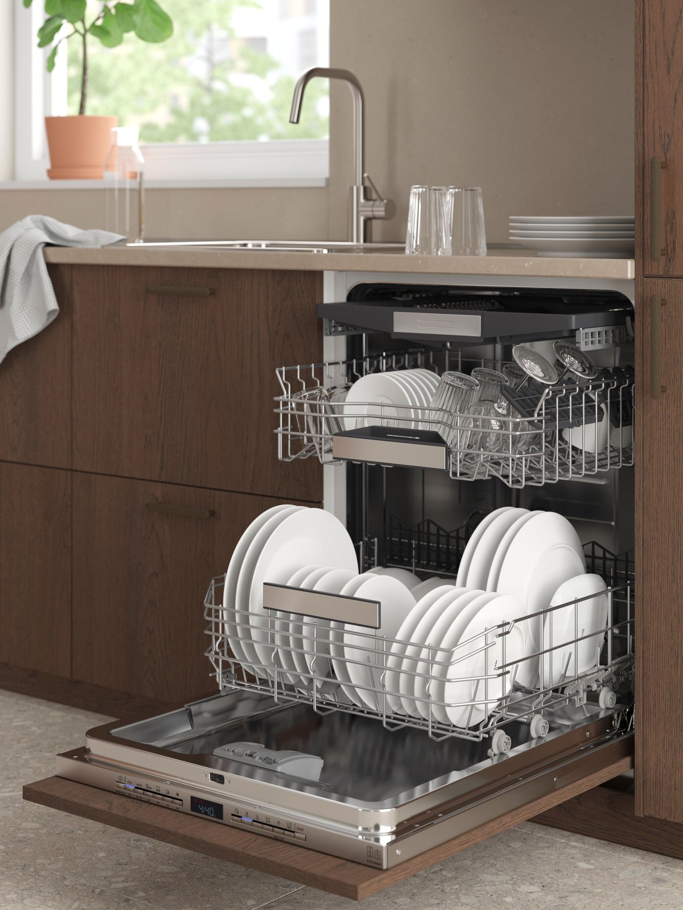 An opened IKEA 700 TORSBODA integrated dishwasher in the kitchen.