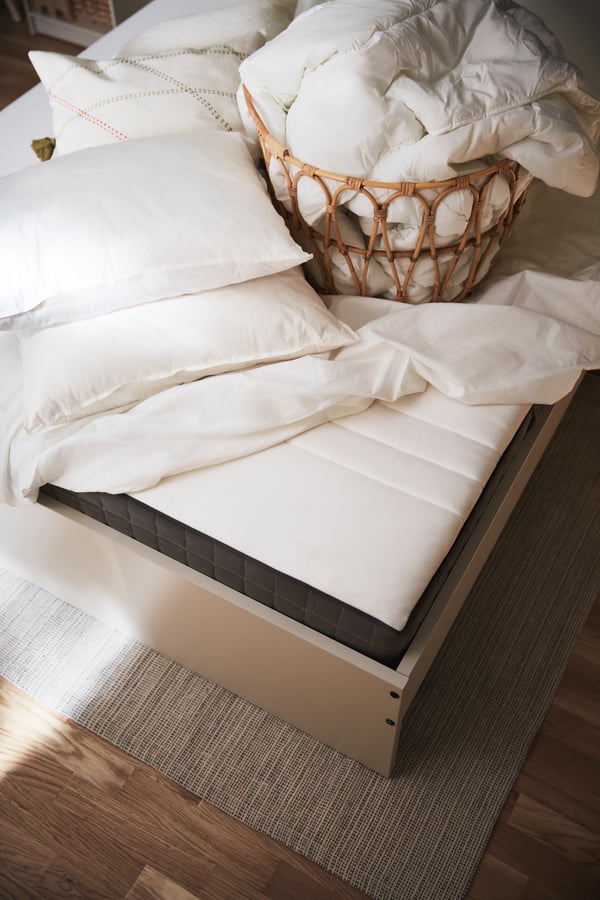 Blue bed pillows and white blanket