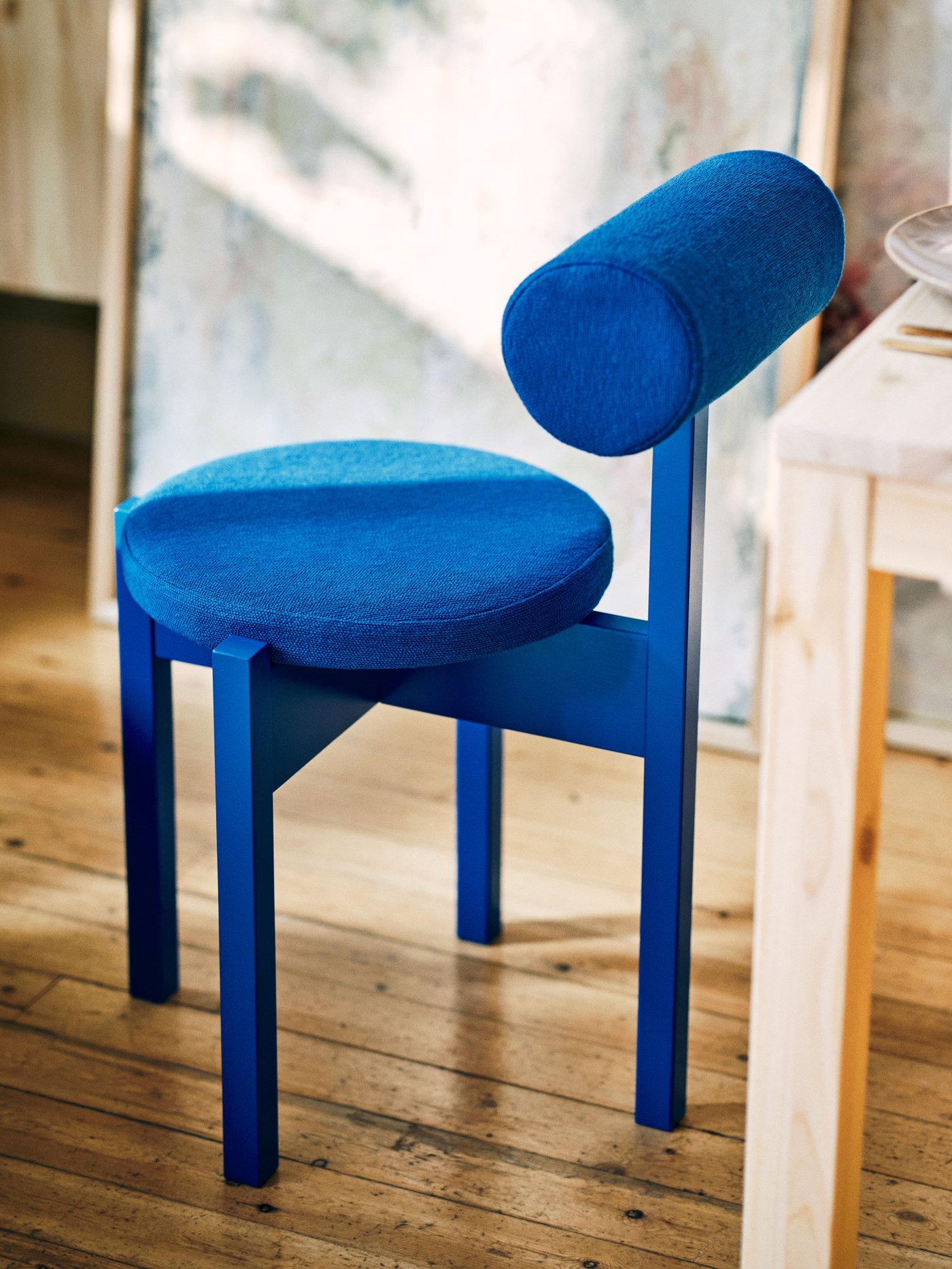 A bright blue/Knäbäck bright blue IKEA PS 2026 chair in the dining room