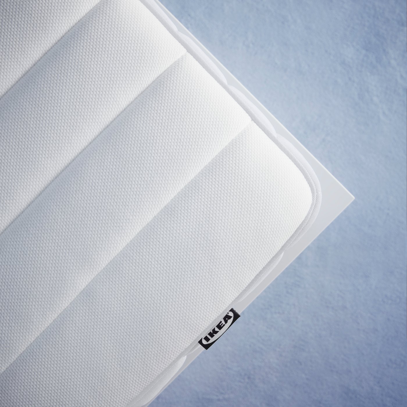 A firm/white VALEVÅG pocket sprung mattress