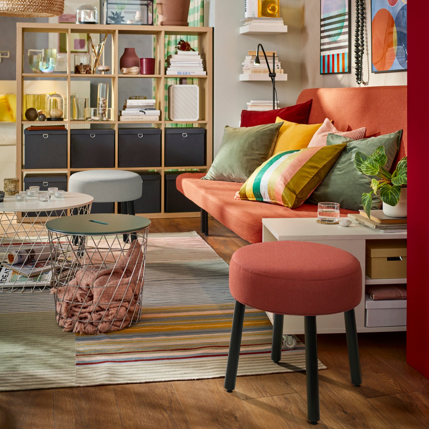 A Diseröd red MÖRTFORS pouffe in the living room