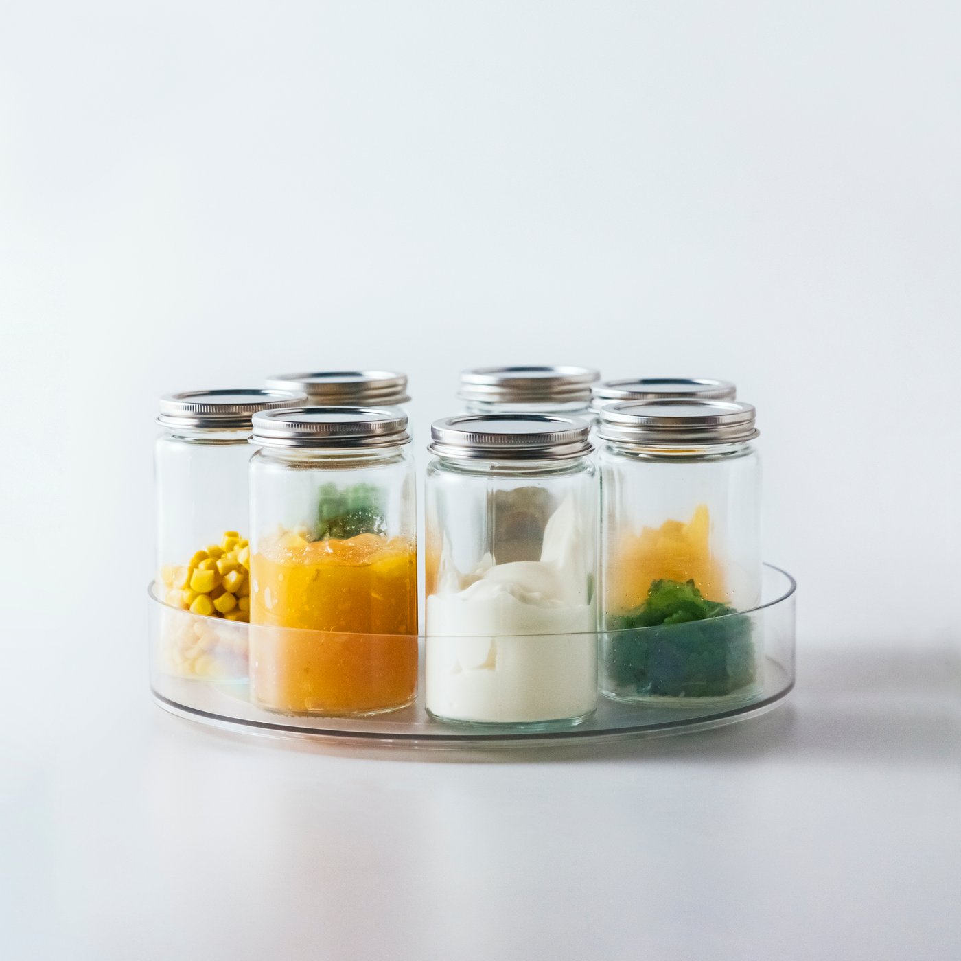 A clear glass/stainless steel GULDFISK spice jar