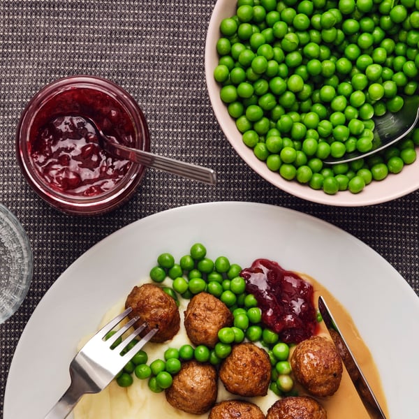 A lunch dish of plant-based protein meatballs with potato salad and kimchi.